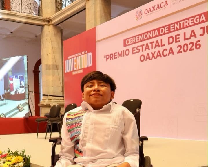 Representante de Ruedas Libres frente al photocall del Premio Estatal de la Juventud Oaxaca 2026